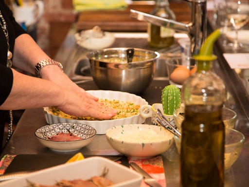 Sandra demonstrating how to prepare 'Flan'